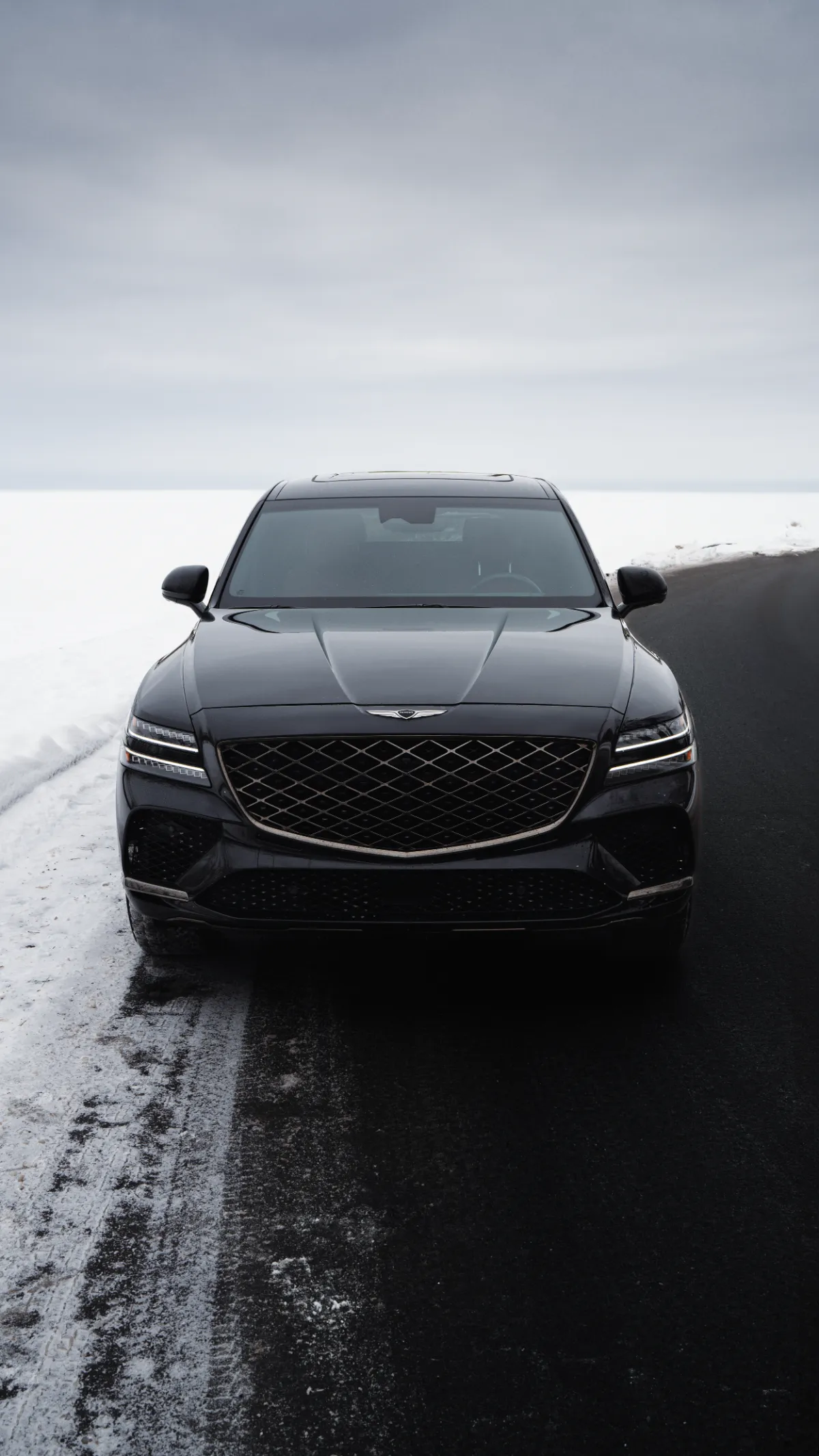 Genesis GV80 on a snowy road, automotive ad